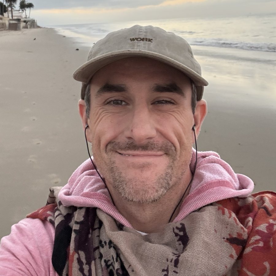 James smiling on the beach at dawn