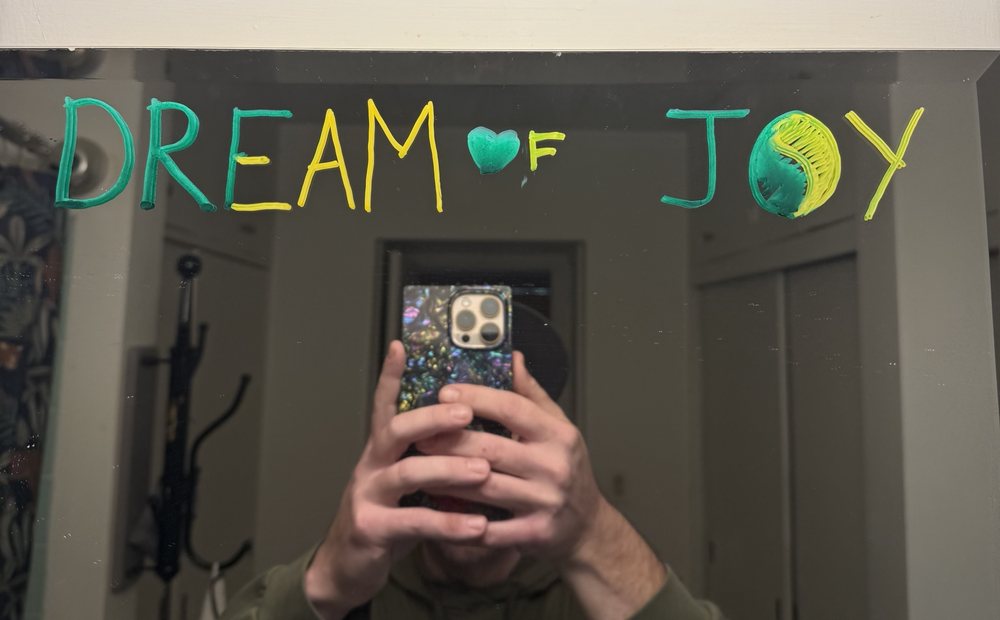 Dream of joy, hand-written in green and yellow on James's mirror